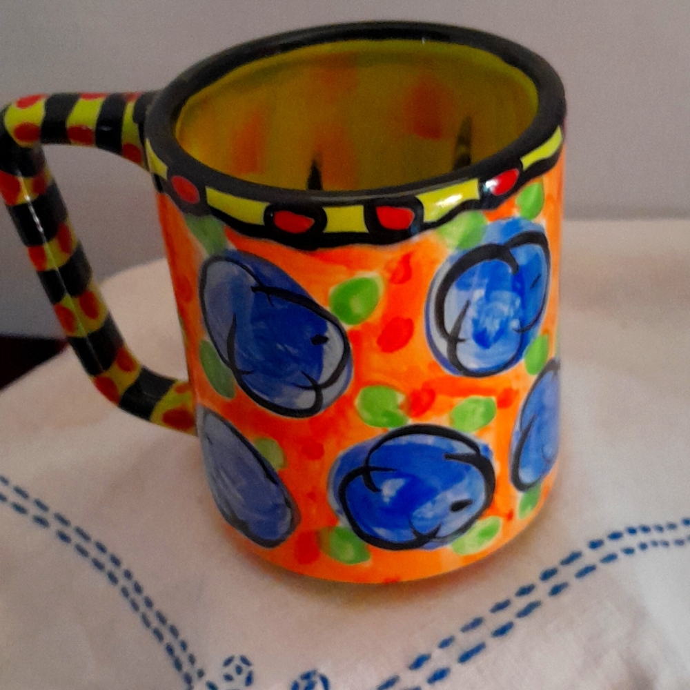 Brightly colored hand made pottery mug